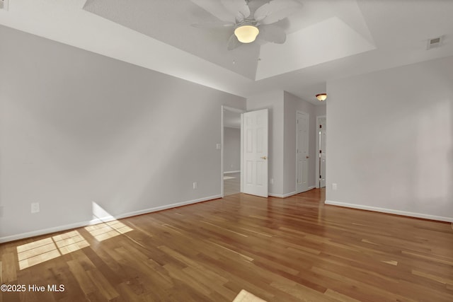 146 Olde Point Rd, Hampstead, NC 28443 - empty room featuring light wood-style flooring, ceiling fan, and a raised ceiling