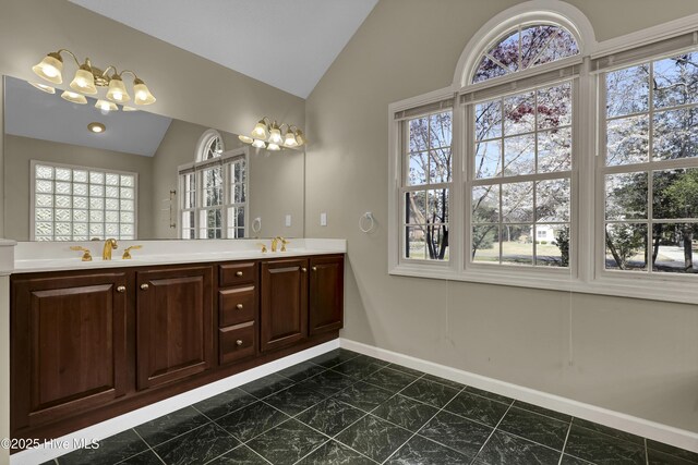 146 Olde Point Rd, Hampstead, NC 28443 - full bathroom featuring vaulted ceiling, plenty of natural light, double vanity, and a chandelier