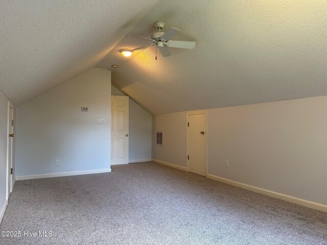 146 Olde Point Rd, Hampstead, NC 28443 - additional living space featuring carpet, a textured ceiling, vaulted ceiling, and a ceiling fan