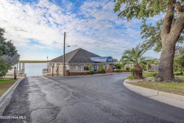 146 Olde Point Rd, Hampstead, NC 28443 - view of front facade featuring brick siding, asphalt driveway, and a gate