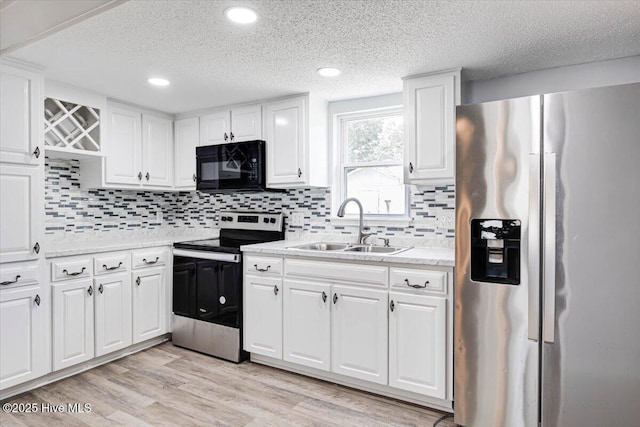 304 N Saratoga St, Stantonsburg, NC 27883 - kitchen featuring appliances with stainless steel finishes, a sink, a textured ceiling, white cabinetry, and recessed lighting