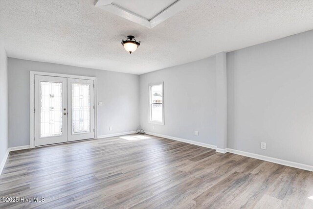 304 N Saratoga St, Stantonsburg, NC 27883 - spare room with wood finished floors, a textured ceiling, french doors, and baseboards