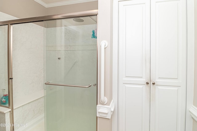 full bath with a stall shower and ornamental molding