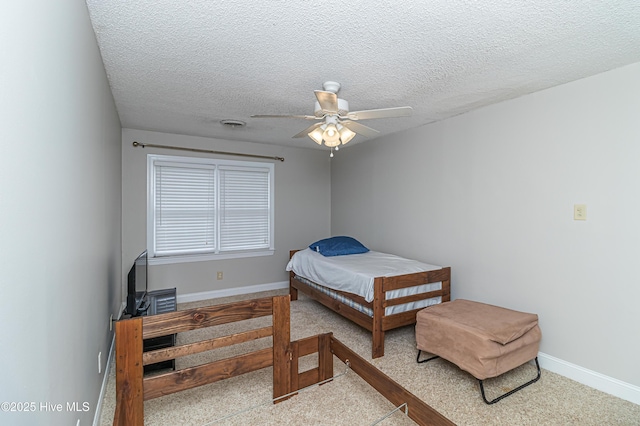 bedroom with baseboards, a textured ceiling, and a ceiling fan
