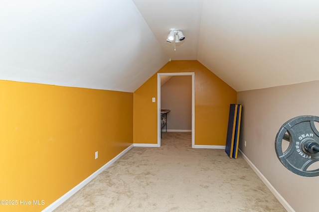 additional living space featuring lofted ceiling, baseboards, and carpet floors