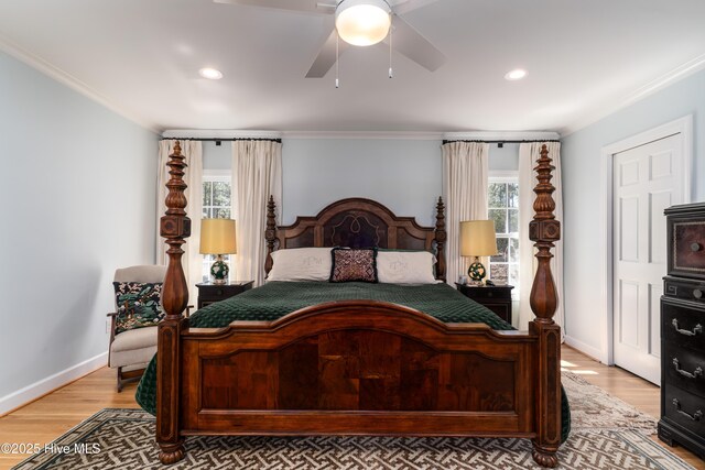 bedroom featuring baseboards, light wood-style floors, and ornamental molding