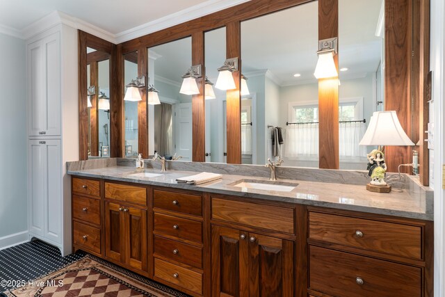 bathroom featuring double vanity, a sink, and ornamental molding