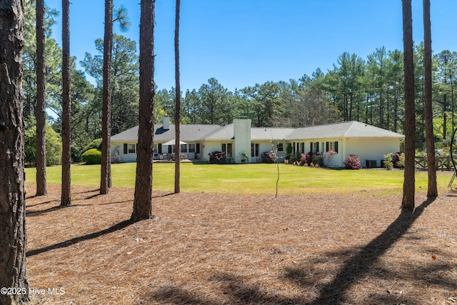 ranch-style house with a front lawn and a chimney
