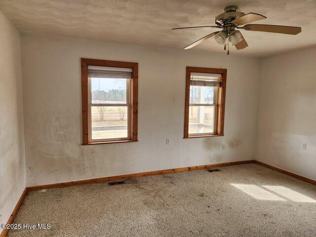 105 Hollowell Rd, Aulander, NC 27805 - carpeted empty room featuring baseboards, a wealth of natural light, and ceiling fan