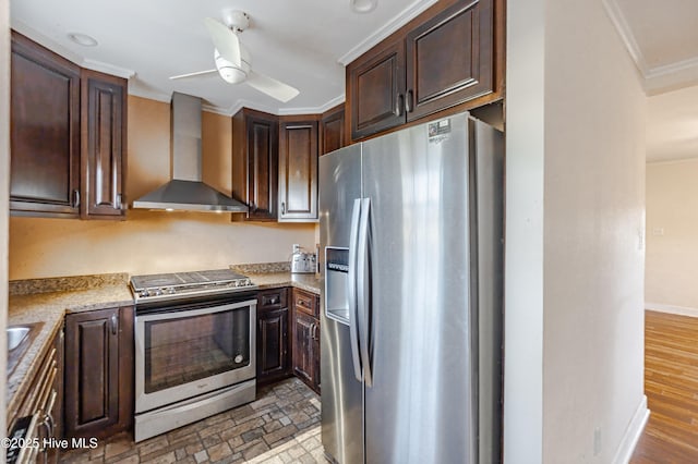 kitchen with a ceiling fan, ornamental molding, stainless steel appliances, dark brown cabinetry, and wall chimney exhaust hood