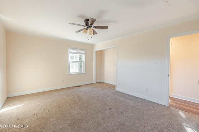 empty room featuring ceiling fan, baseboards, and ornamental molding