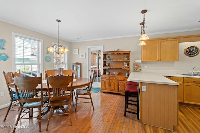 6 White Ln, Oak Island, NC 28465 - dining room with an inviting chandelier, light wood-type flooring, and crown molding