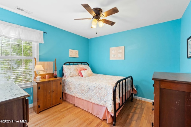 6 White Ln, Oak Island, NC 28465 - bedroom featuring baseboards, visible vents, a ceiling fan, and light wood-style floors