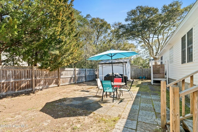6 White Ln, Oak Island, NC 28465 - view of yard with a gazebo, a fenced backyard, and a patio area