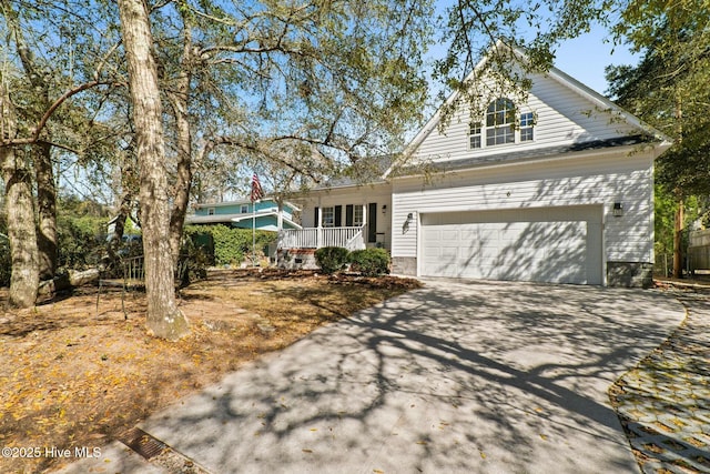 6 White Ln, Oak Island, NC 28465 - traditional home featuring a porch, driveway, and an attached garage