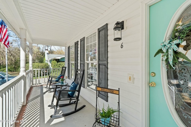 6 White Ln, Oak Island, NC 28465 - balcony featuring a porch