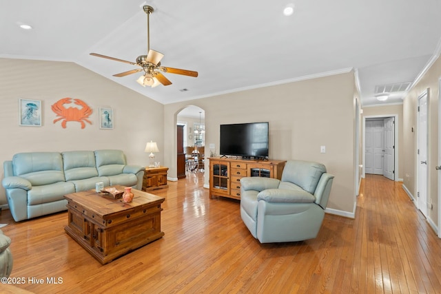 6 White Ln, Oak Island, NC 28465 - living room with visible vents, light wood-style floors, a ceiling fan, and arched walkways
