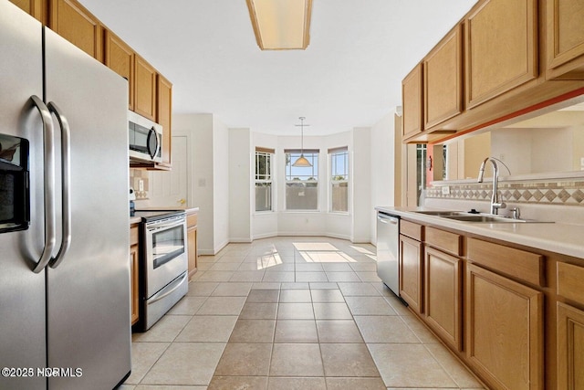 kitchen with a sink, light countertops, tasteful backsplash, and stainless steel appliances