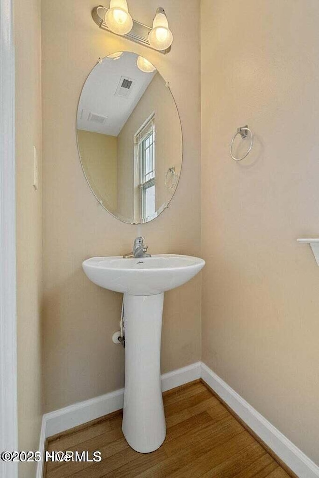 bathroom featuring baseboards and wood finished floors