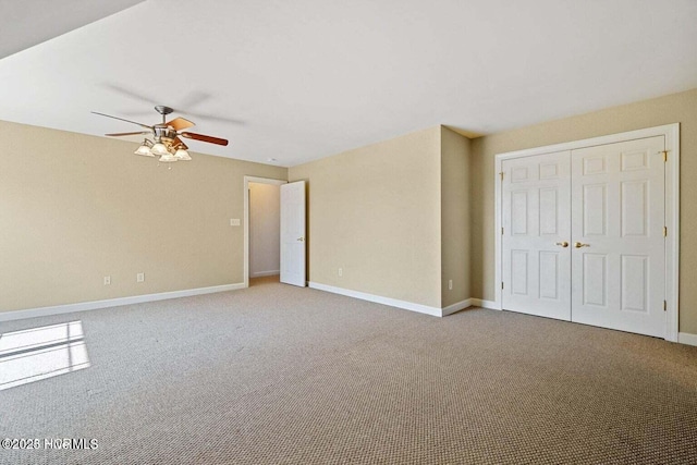 empty room featuring baseboards, carpet floors, and a ceiling fan