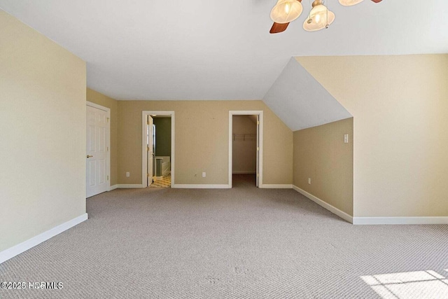 bonus room with carpet flooring, baseboards, and vaulted ceiling