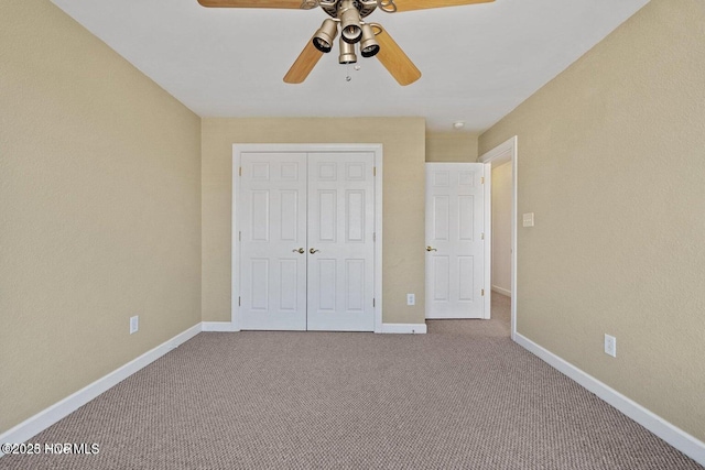 unfurnished bedroom with baseboards, carpet floors, a closet, and ceiling fan