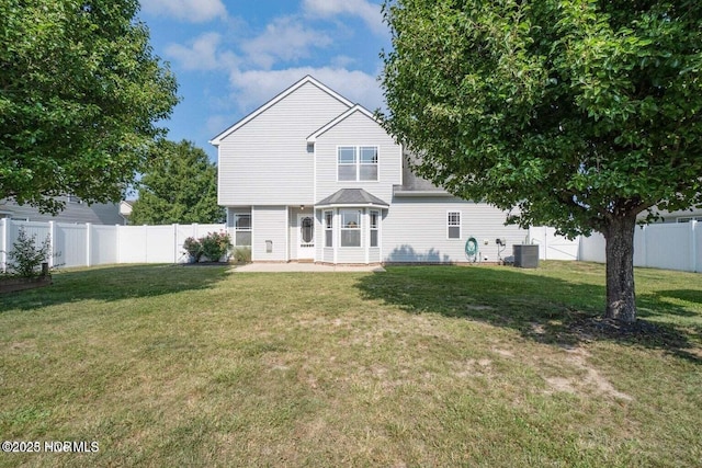 back of property with cooling unit, a lawn, a fenced backyard, and a patio area