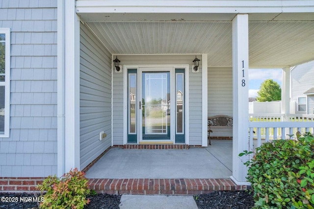 view of exterior entry with a porch