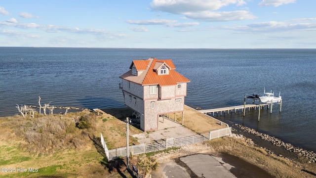 exterior space featuring a water view and fence