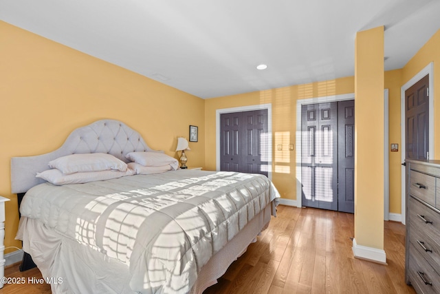 bedroom featuring baseboards and light wood-type flooring