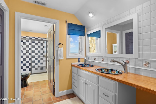 full bath with vanity, lofted ceiling, backsplash, tile patterned floors, and visible vents