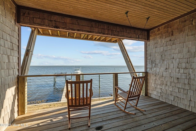 wooden terrace featuring a water view