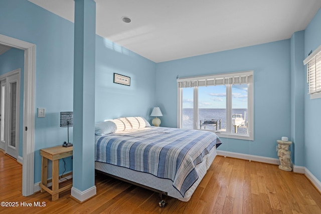 bedroom with baseboards and light wood-style flooring
