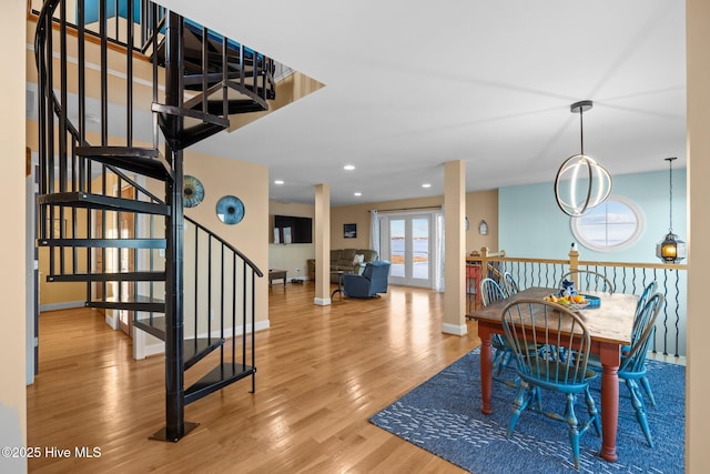 dining space featuring baseboards, stairs, wood finished floors, and recessed lighting