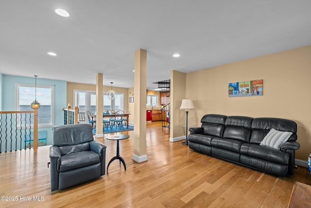 living room with baseboards, light wood-style floors, and recessed lighting