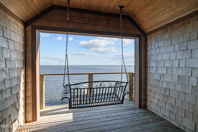 wooden deck featuring a water view