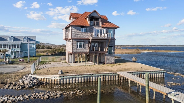 dock area featuring a balcony and a water view