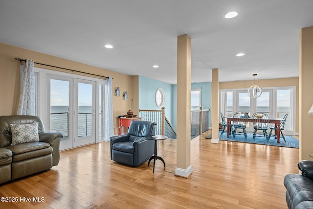 living room featuring baseboards, light wood-style floors, and recessed lighting