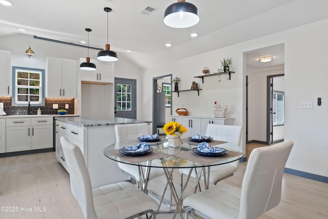 dining room with vaulted ceiling, plenty of natural light, light wood-style flooring, visible vents, and recessed lighting