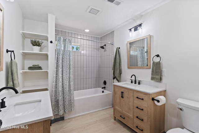 full bath with shower / bath combo, wood finished floors, vanity, toilet, and visible vents