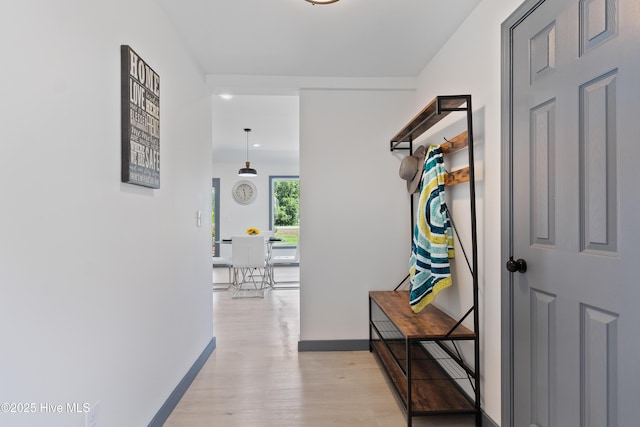 hall featuring recessed lighting, light wood finished floors, and baseboards