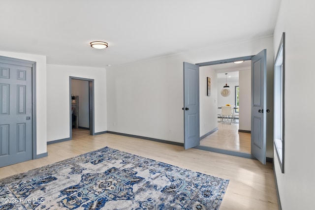 unfurnished bedroom featuring light wood-style flooring and baseboards