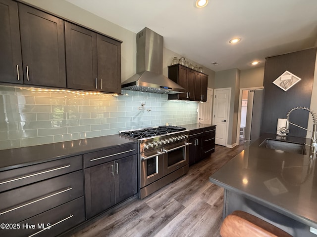 1123 Mill Run Rd, Sneads Ferry, NC 28460 - kitchen with dark countertops, dark wood-style floors, wall chimney range hood, range with two ovens, and a sink