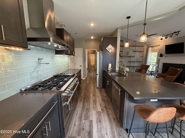 1123 Mill Run Rd, Sneads Ferry, NC 28460 - kitchen featuring ventilation hood, a sink, stainless steel appliances, open floor plan, and a kitchen bar