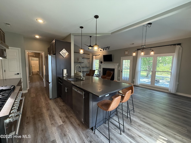 1123 Mill Run Rd, Sneads Ferry, NC 28460 - kitchen featuring dark countertops, a sink, stainless steel appliances, open floor plan, and wood finished floors