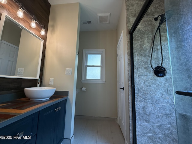 1123 Mill Run Rd, Sneads Ferry, NC 28460 - bathroom featuring visible vents, a tile shower, and vanity