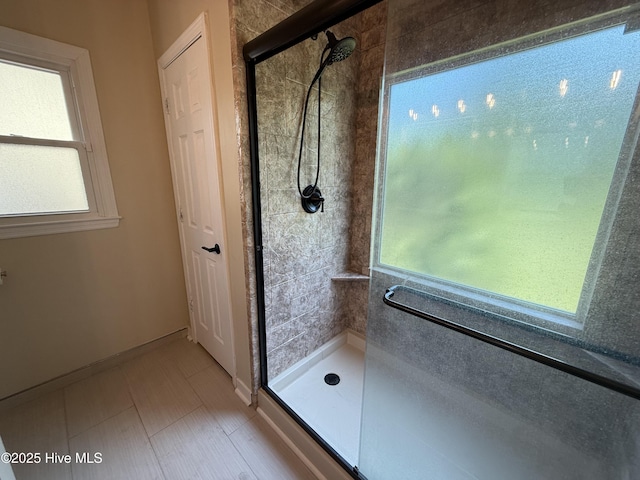 1123 Mill Run Rd, Sneads Ferry, NC 28460 - bathroom featuring baseboards, a healthy amount of sunlight, and a shower stall