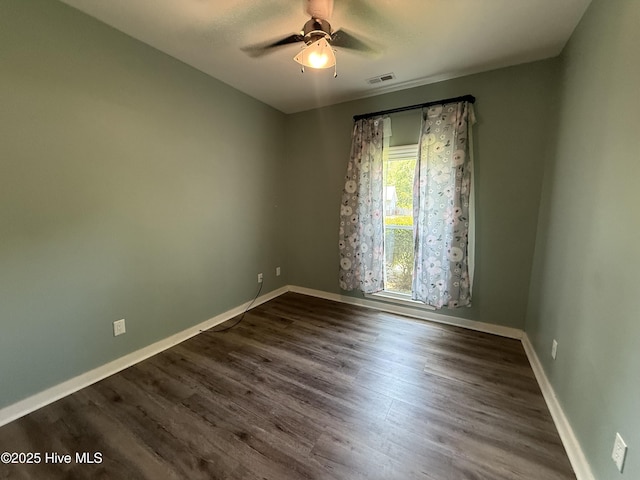 1123 Mill Run Rd, Sneads Ferry, NC 28460 - spare room with a ceiling fan, baseboards, visible vents, and dark wood-style floors