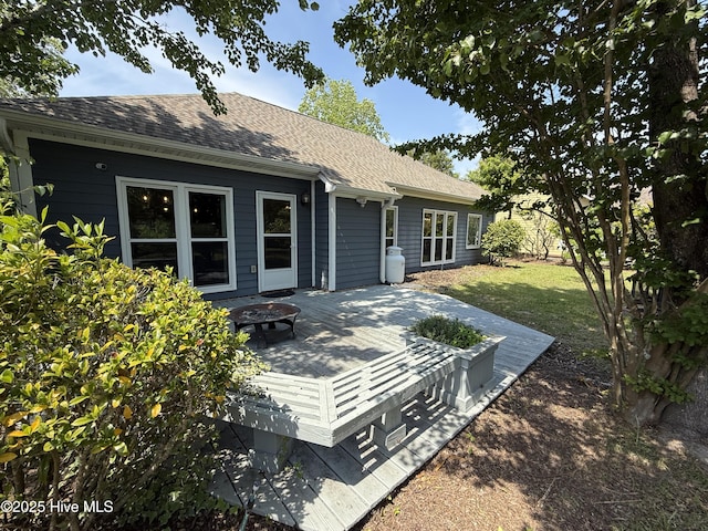 1123 Mill Run Rd, Sneads Ferry, NC 28460 - back of property featuring roof with shingles, a wooden deck, a lawn, and a fire pit