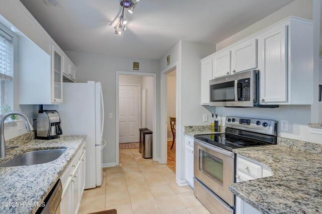 1414 Kellum Ct, Wilmington, NC 28412 - kitchen featuring appliances with stainless steel finishes, a sink, white cabinetry, and light stone countertops